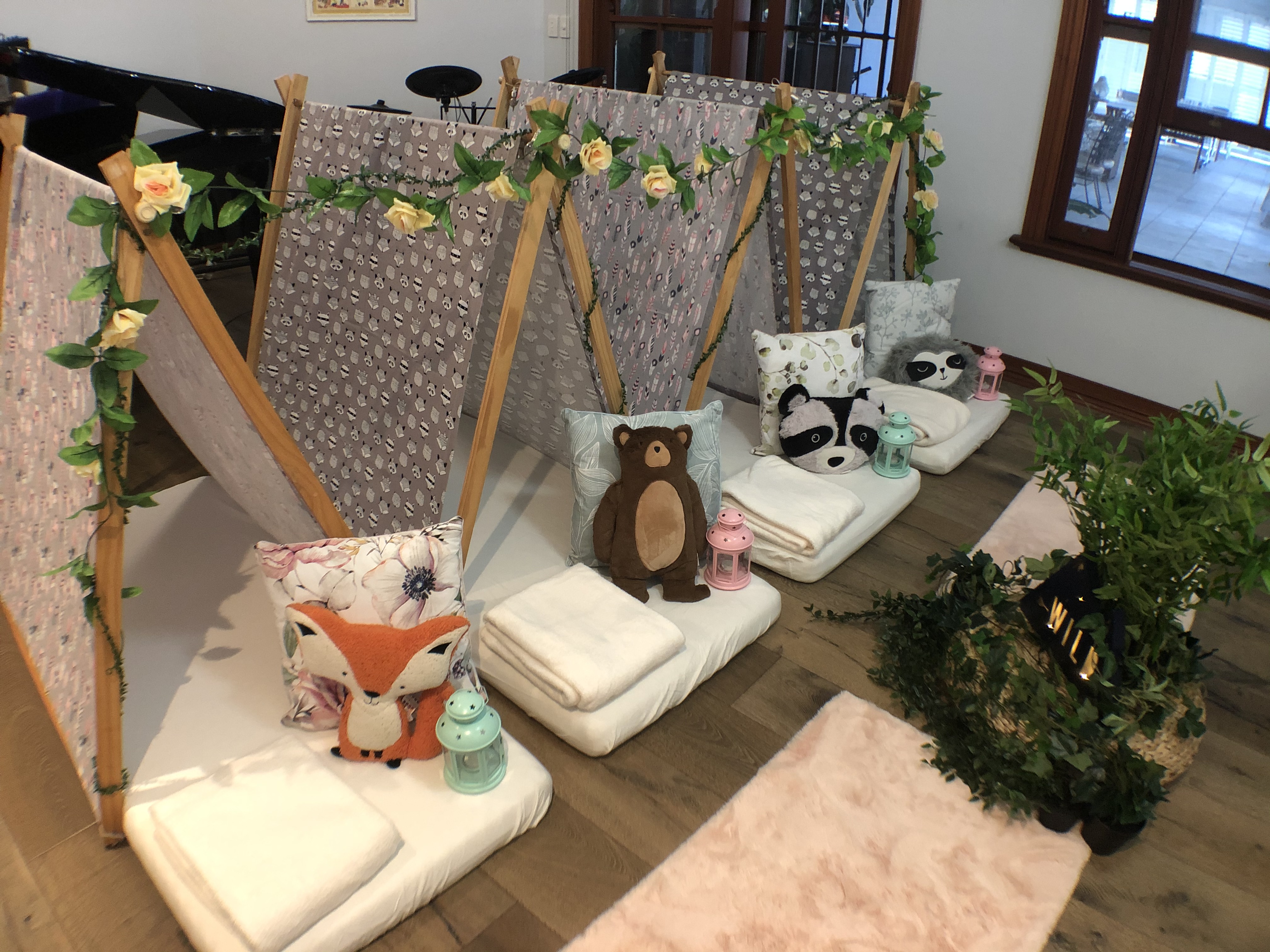 Teepee tents with stuffed animals, pillows, lights
